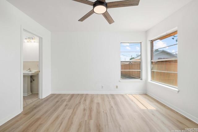 spare room featuring ceiling fan and light wood-type flooring