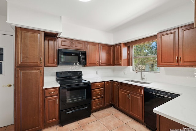 kitchen featuring backsplash, sink, light tile patterned floors, and black appliances