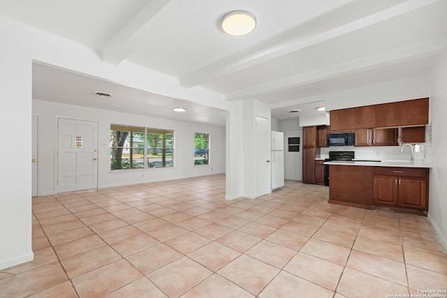 kitchen with black appliances, sink, light tile patterned floors, and beamed ceiling