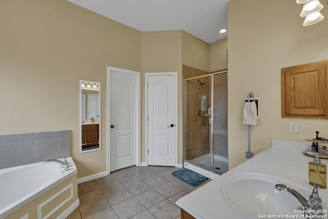 bathroom with tile patterned flooring, vanity, and independent shower and bath