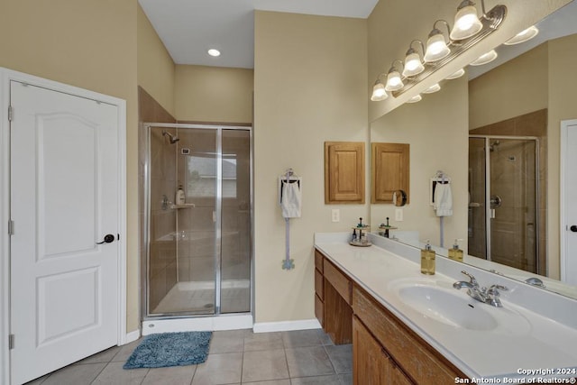 bathroom with tile patterned flooring, vanity, and an enclosed shower