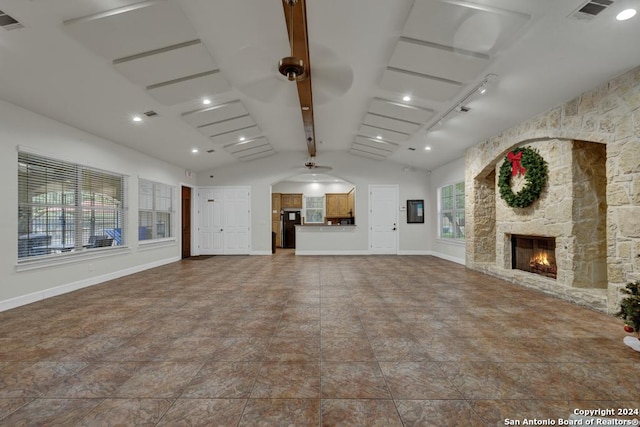 unfurnished living room featuring lofted ceiling with beams and a fireplace