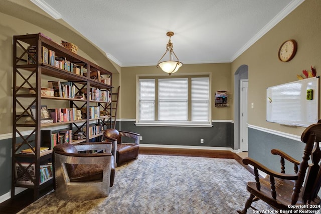 sitting room featuring wood-type flooring and crown molding