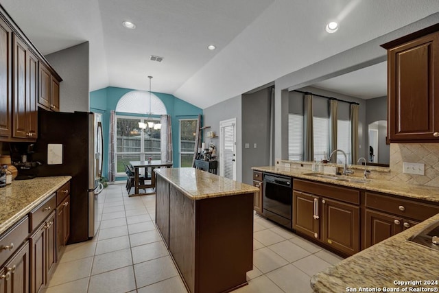 kitchen with tasteful backsplash, vaulted ceiling, black appliances, sink, and pendant lighting