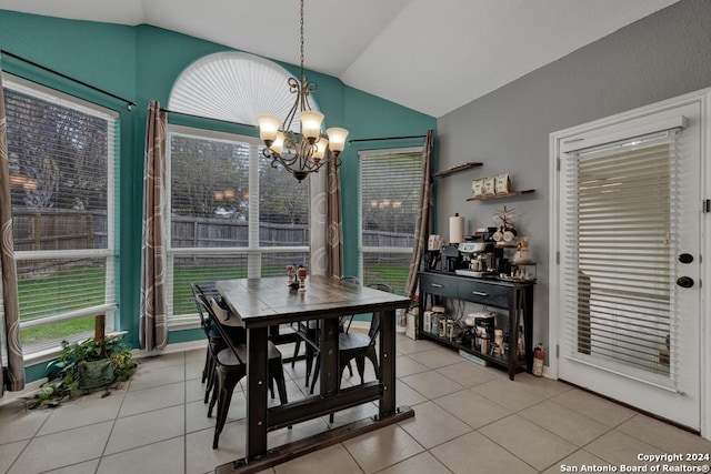 tiled dining room featuring a chandelier and lofted ceiling