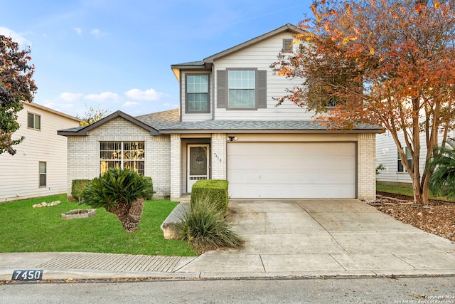 front facade featuring a garage and a front yard