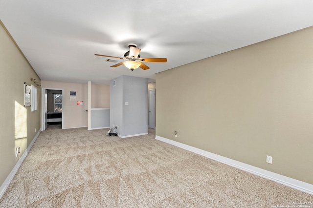 unfurnished room with ceiling fan and light carpet