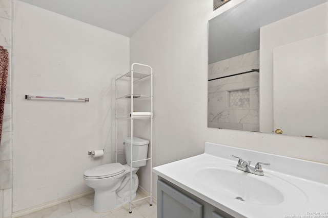 bathroom featuring a shower, vanity, and toilet