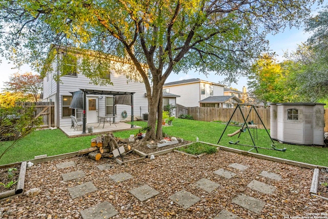 view of yard featuring a pergola, a storage unit, a patio area, and a playground