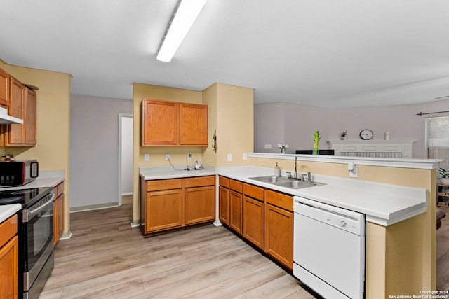 kitchen with white dishwasher, stainless steel range with electric stovetop, kitchen peninsula, and sink