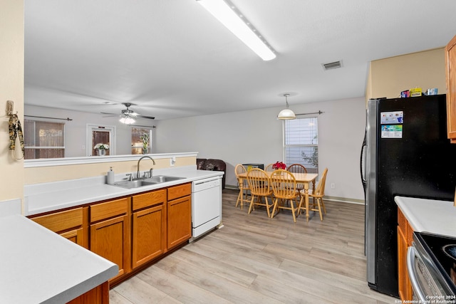 kitchen with ceiling fan, dishwasher, sink, hanging light fixtures, and stove