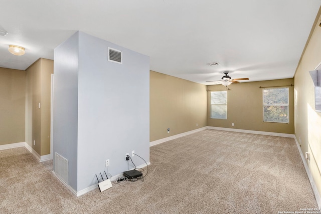 carpeted spare room featuring ceiling fan