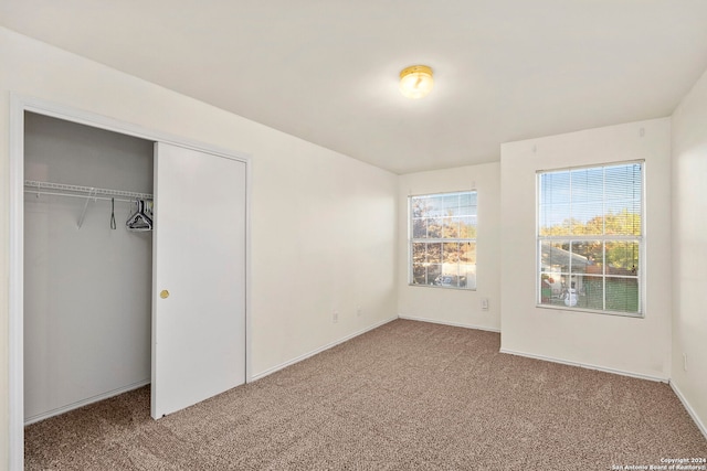 unfurnished bedroom with carpet flooring and a closet