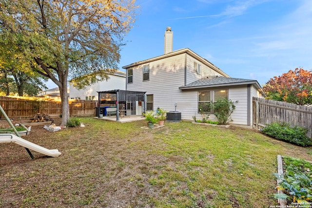 back of house featuring a yard, a patio, and central AC unit