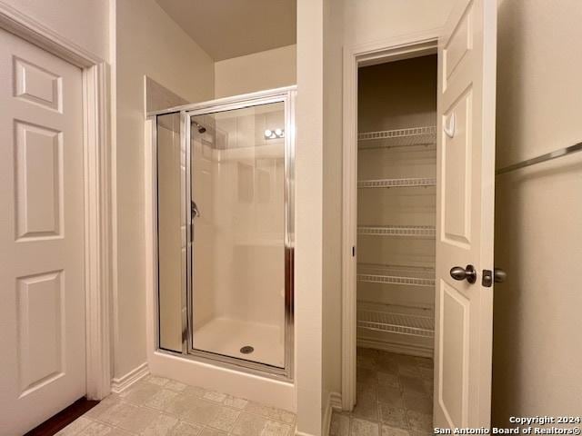 bathroom with a shower with shower door