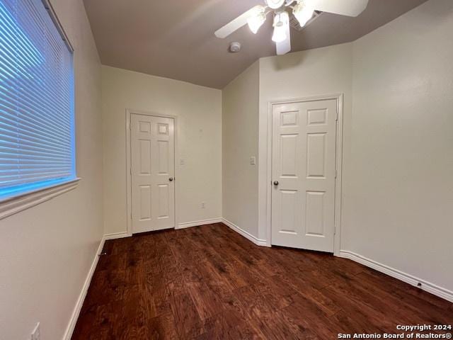 spare room featuring ceiling fan and dark hardwood / wood-style flooring