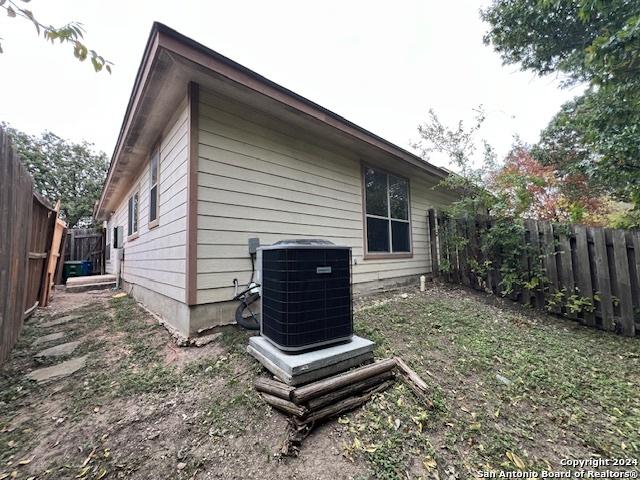 view of side of home featuring central AC unit