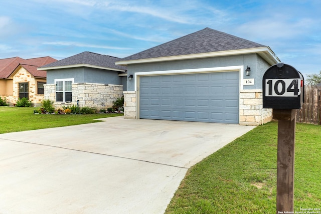 view of front of house with a garage and a front lawn