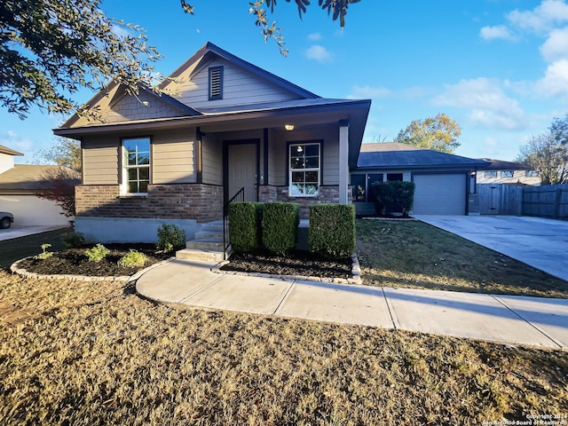 474 Wind Gust, New Braunfels, TX 78130 - view of front of property with an attached garage, concrete driveway, covered porch, and brick siding
