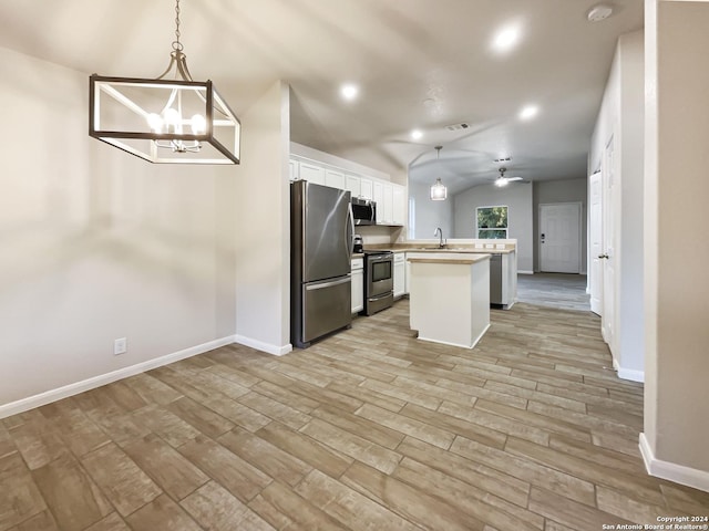474 Wind Gust, New Braunfels, TX 78130 - kitchen featuring appliances with stainless steel finishes, a chandelier, white cabinets, light wood finished floors, and lofted ceiling