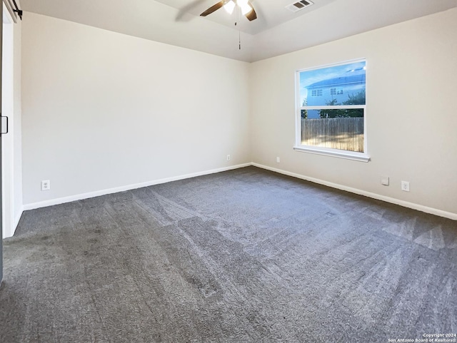 carpeted spare room with ceiling fan