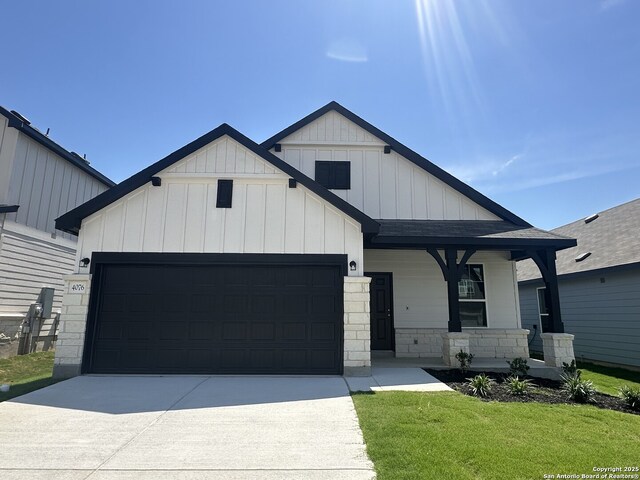 4076 Paddock Trl, Seguin, TX 78155 - view of front of property with board and batten siding, a garage, stone siding, and driveway