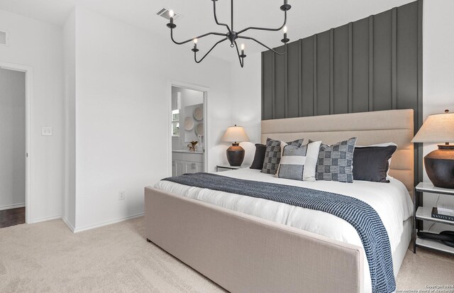 4076 Paddock Trl, Seguin, TX 78155 - carpeted bedroom featuring a chandelier and ensuite bath
