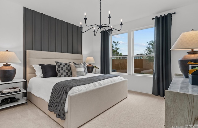 bedroom featuring a notable chandelier and light colored carpet