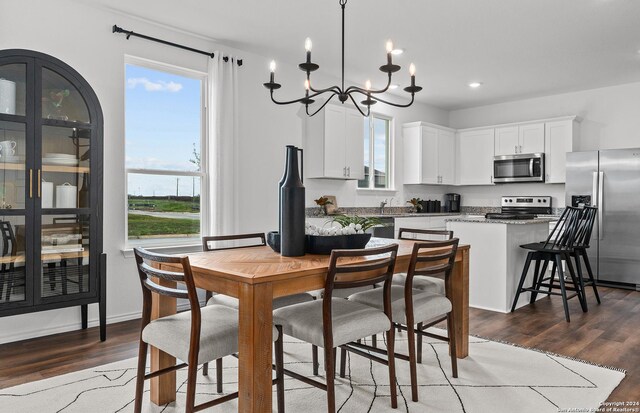 4076 Paddock Trl, Seguin, TX 78155 - dining area with a chandelier, wood finished floors, and recessed lighting