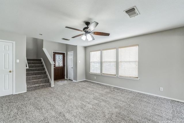 interior space featuring ceiling fan and carpet floors