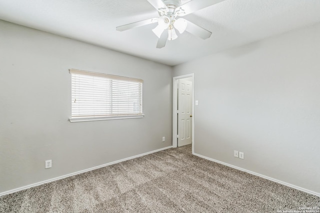 unfurnished room featuring ceiling fan and light carpet