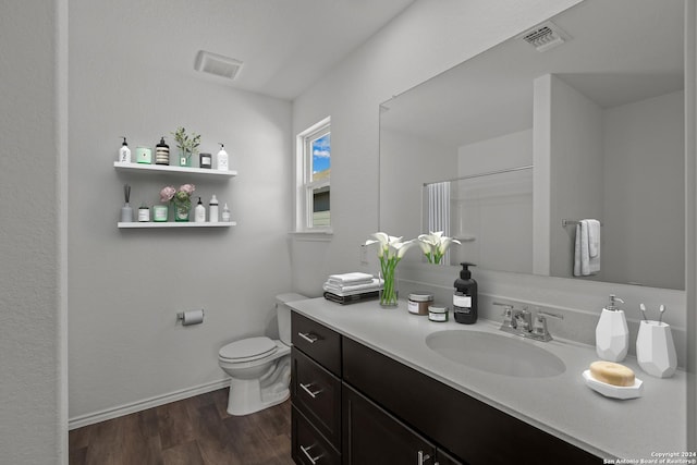 bathroom featuring vanity, curtained shower, toilet, and wood-type flooring