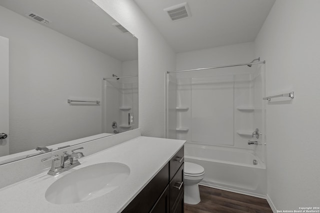 full bathroom with wood-type flooring, vanity, shower / bath combination, and toilet