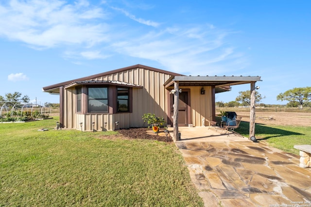 view of front of property with a patio and a front yard