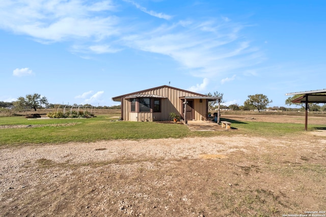 exterior space with a rural view and an outdoor structure