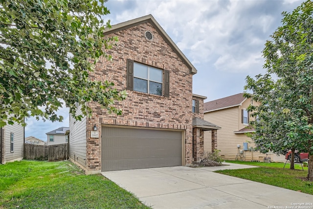 view of front property featuring a front yard and a garage