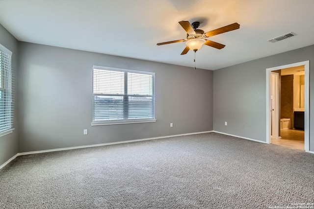 spare room with ceiling fan and light colored carpet