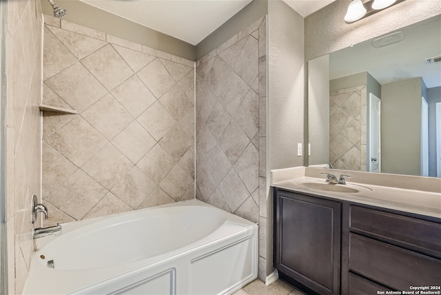 bathroom featuring vanity and tiled shower / bath