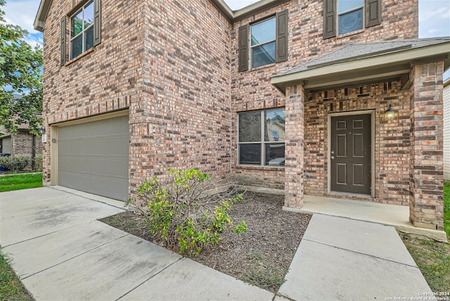 doorway to property with a garage