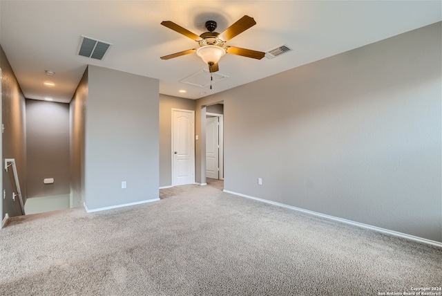 carpeted spare room featuring ceiling fan