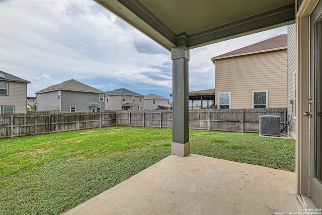 view of yard featuring cooling unit and a patio