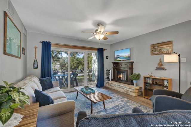 living room featuring ceiling fan and hardwood / wood-style floors