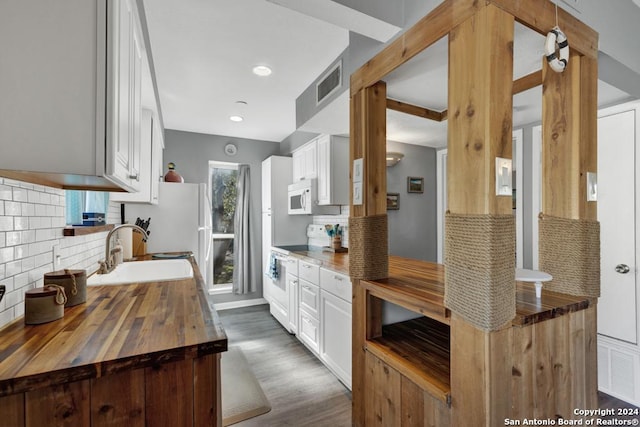 kitchen featuring sink, tasteful backsplash, wooden counters, white appliances, and white cabinets