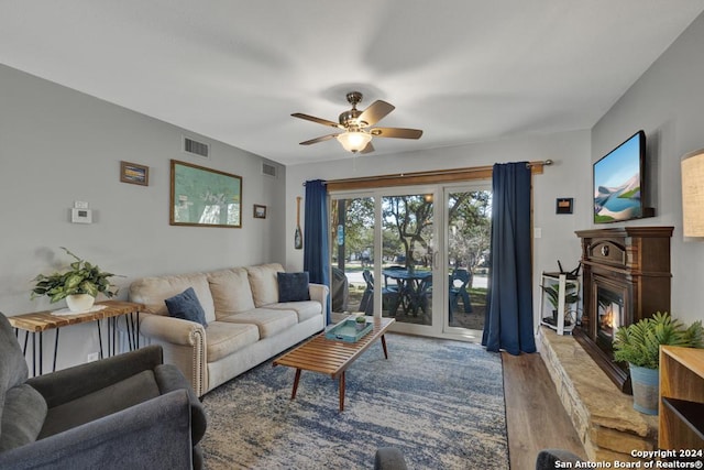 living room featuring ceiling fan and wood-type flooring