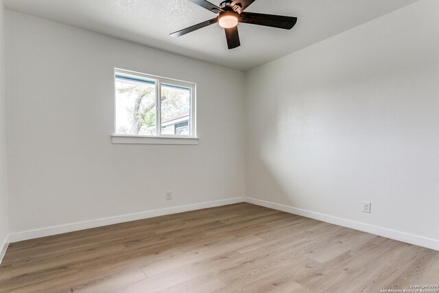 empty room featuring ceiling fan and light hardwood / wood-style floors