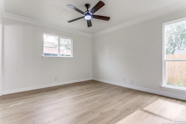 empty room with plenty of natural light, ceiling fan, light wood-type flooring, and ornamental molding