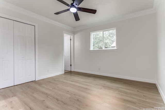 unfurnished bedroom with a closet, ceiling fan, crown molding, and light wood-type flooring