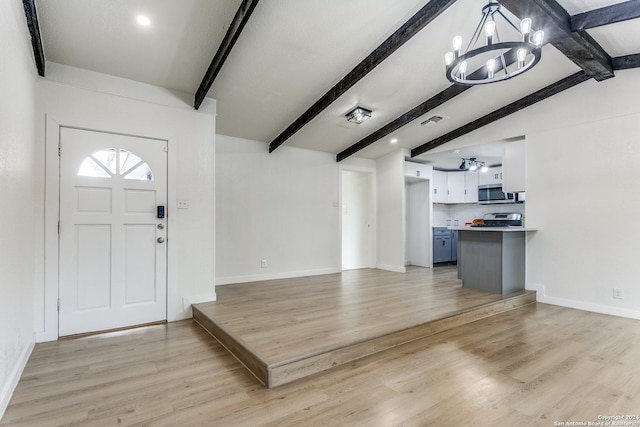 foyer featuring a notable chandelier, lofted ceiling with beams, and light hardwood / wood-style floors