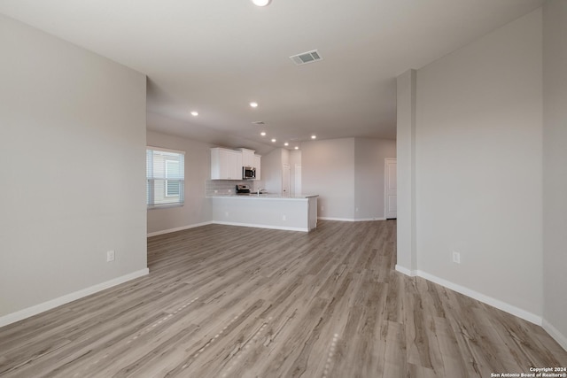 unfurnished living room with light wood-type flooring