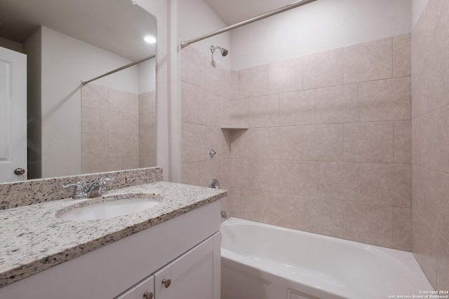 bathroom with vanity and tiled shower / bath